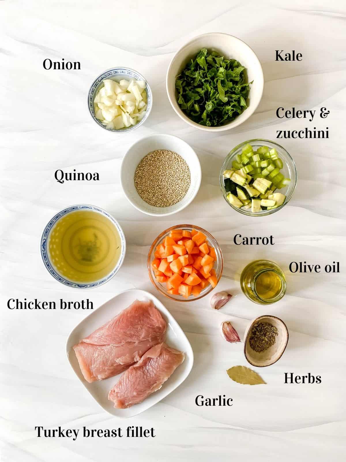 all the ingredients to make turkey quinoa soup in small bowls.
