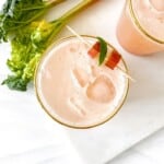 overhead view of two glasses of rhubarb mocktail next to stems of rhubarb.