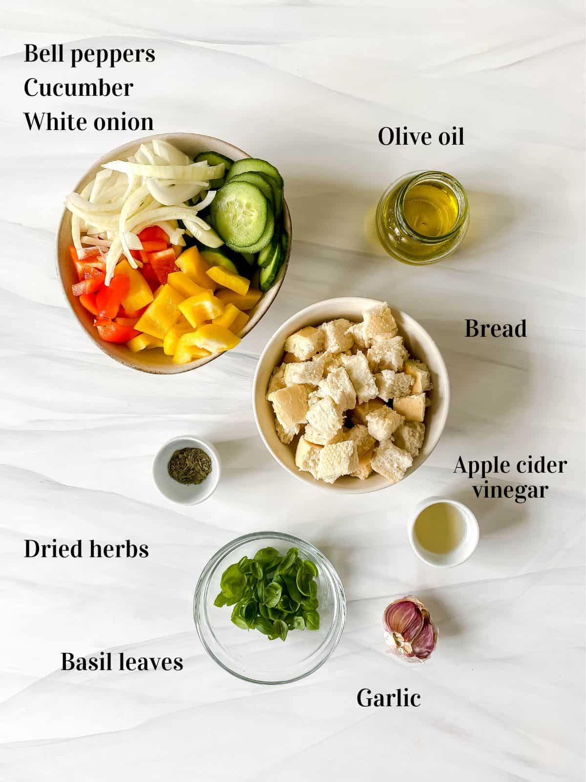 all the ingredients to make panzanella in a small bowls.