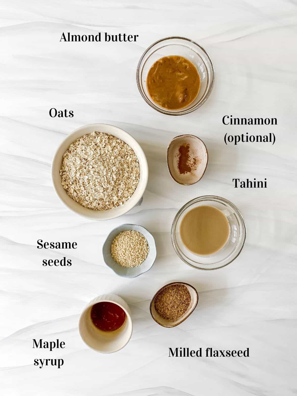 individually labelled ingredients to make sesame energy balls including oats and tahini.