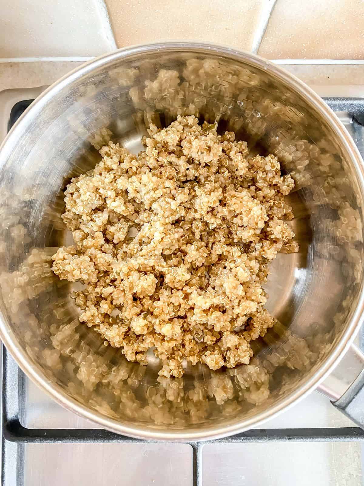 cooked quinoa in a metal pot.