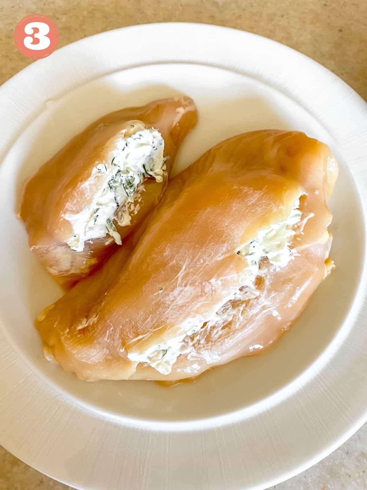 two chicken breasts stuffed with herb cream cheese labelled number three.