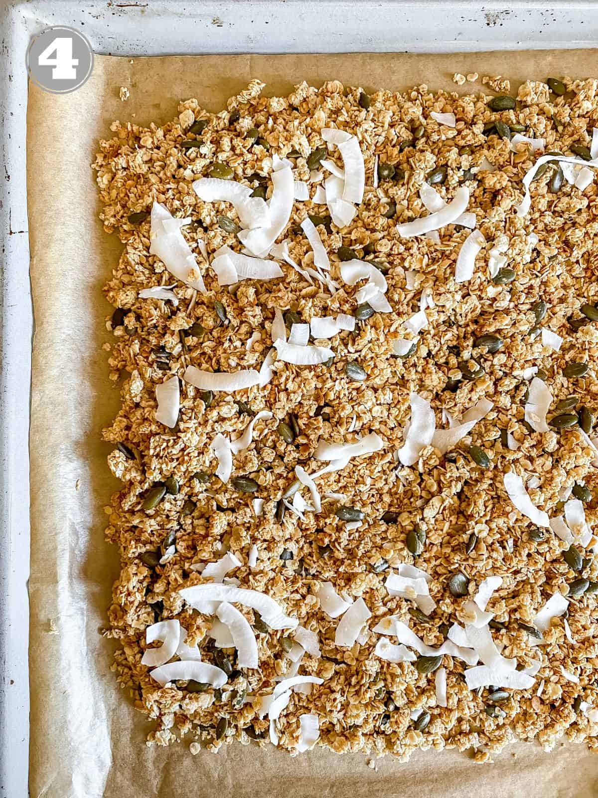 granola with coconut on it on a baking tray.