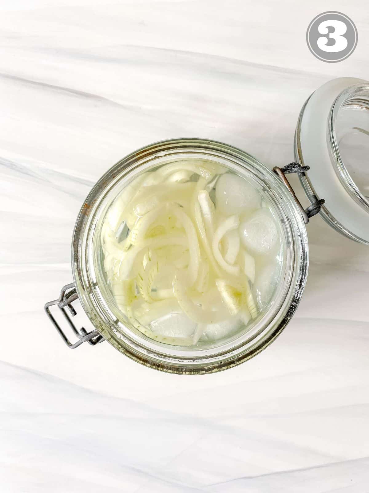 onions in ice water in a glass jar labelled number three.