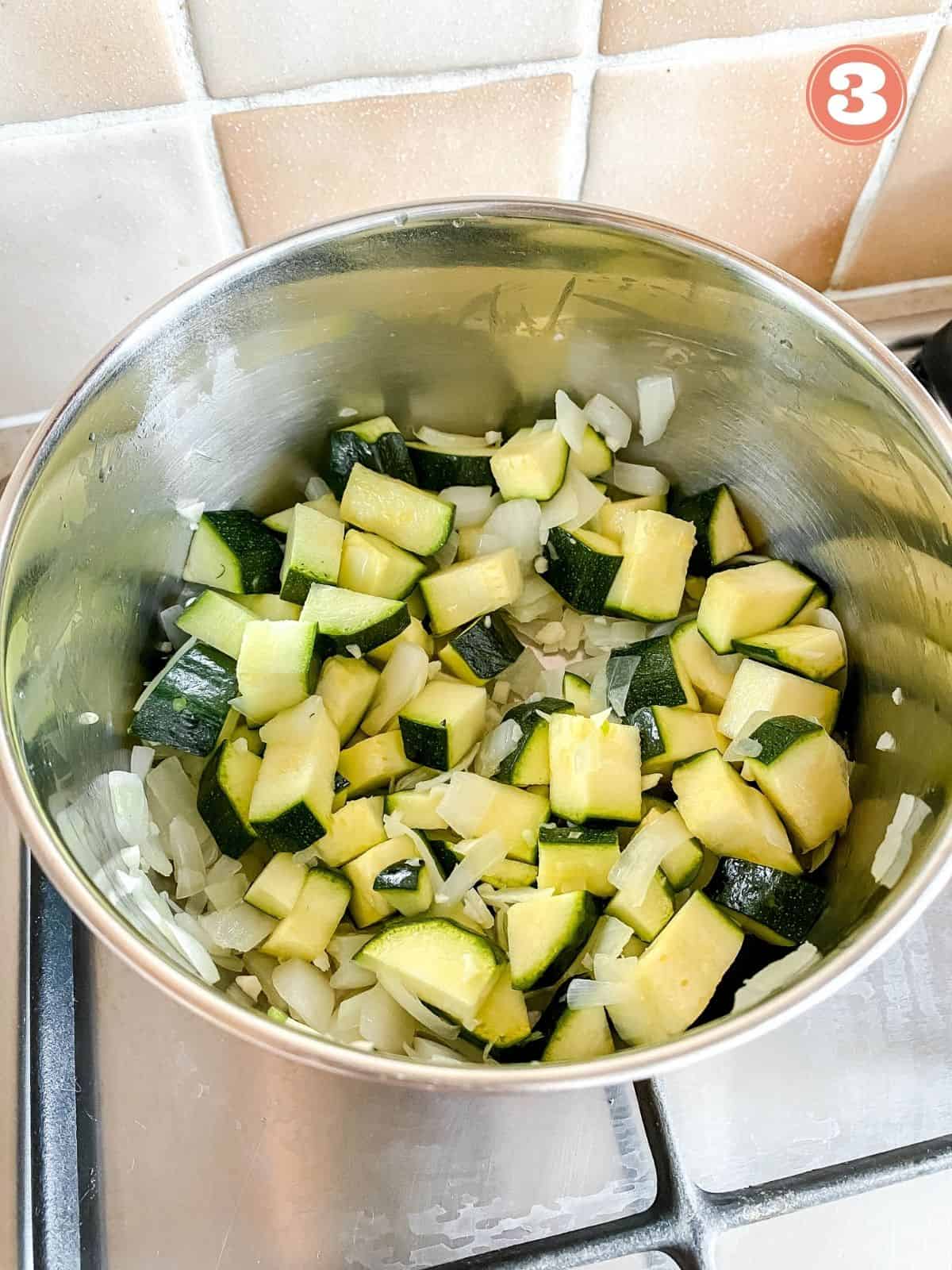 zucchini, onion and garlic in a pot labelled number three.