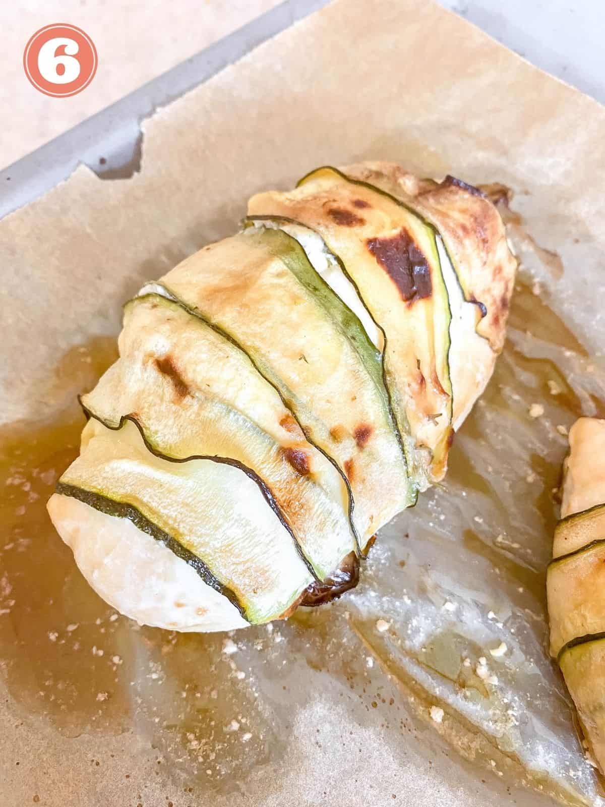 zucchini wrapped chicken on a baking tray.