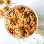 almond vanilla granola in a glass on a spotty cloth.