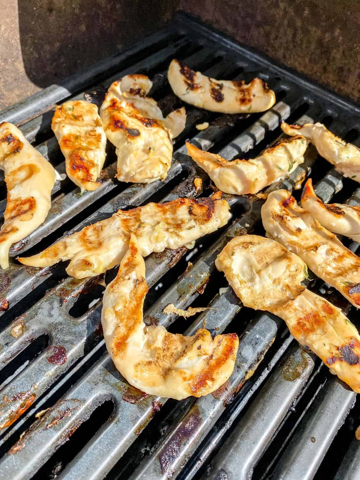 pieces of chicken on a BBQ grill.