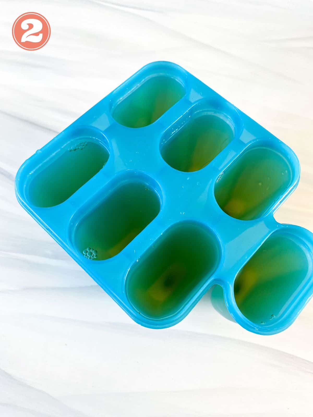 apple juice in a blue popsicle mold.