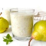 lychee smoothie in two glasses next to pears and mint.