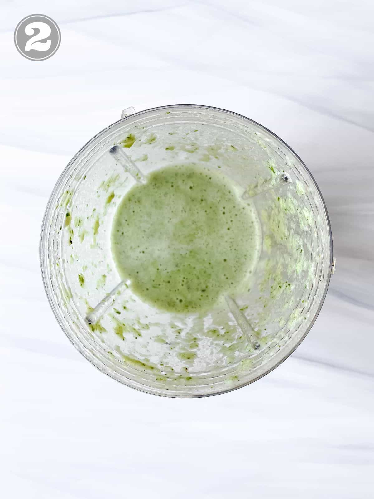 celery cucumber smoothie in a blender cup.