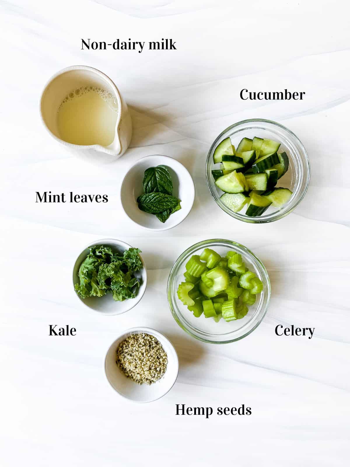 labelled ingredients to make celery cucumber smoothie in small bowls.