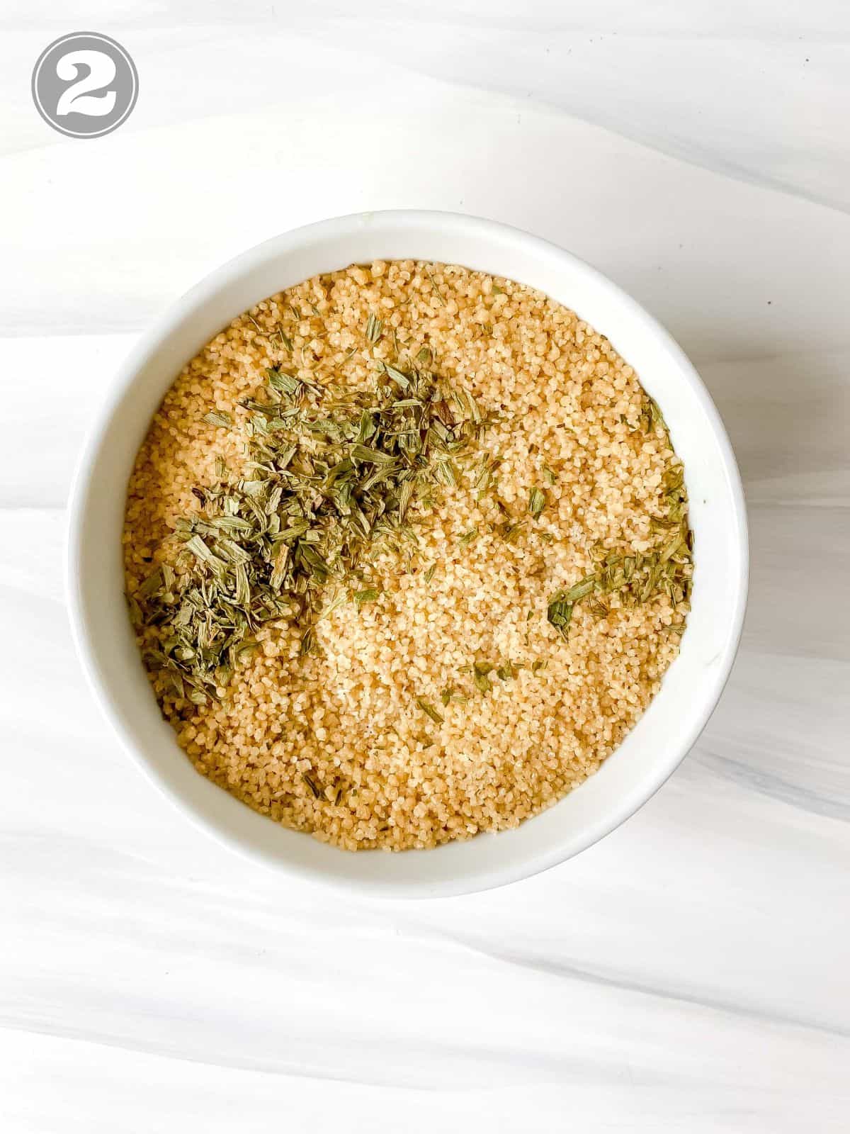 couscous in a white bowl with dried herbs labelled number two.