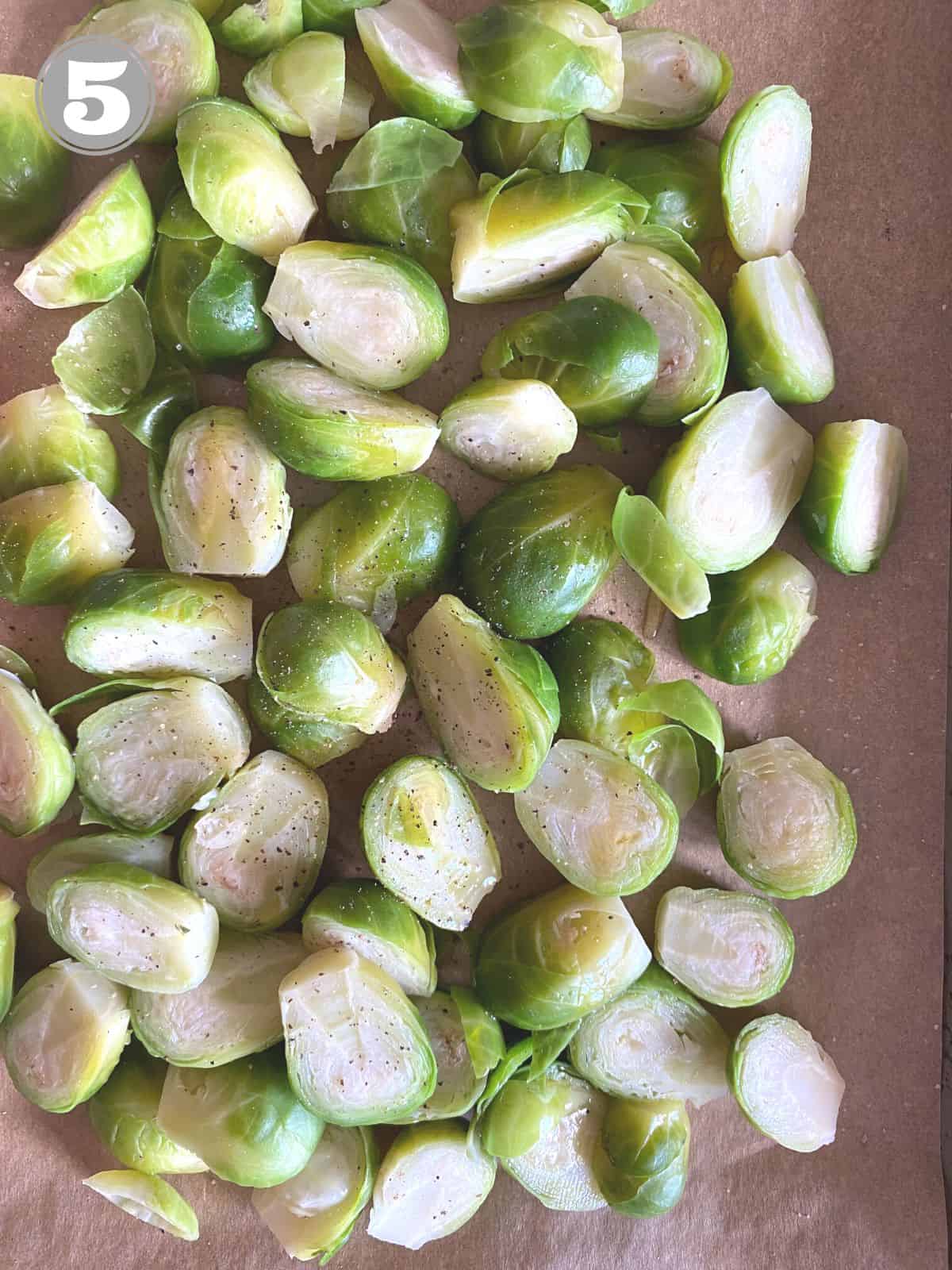 halved Brussels sprouts on parchment paper.