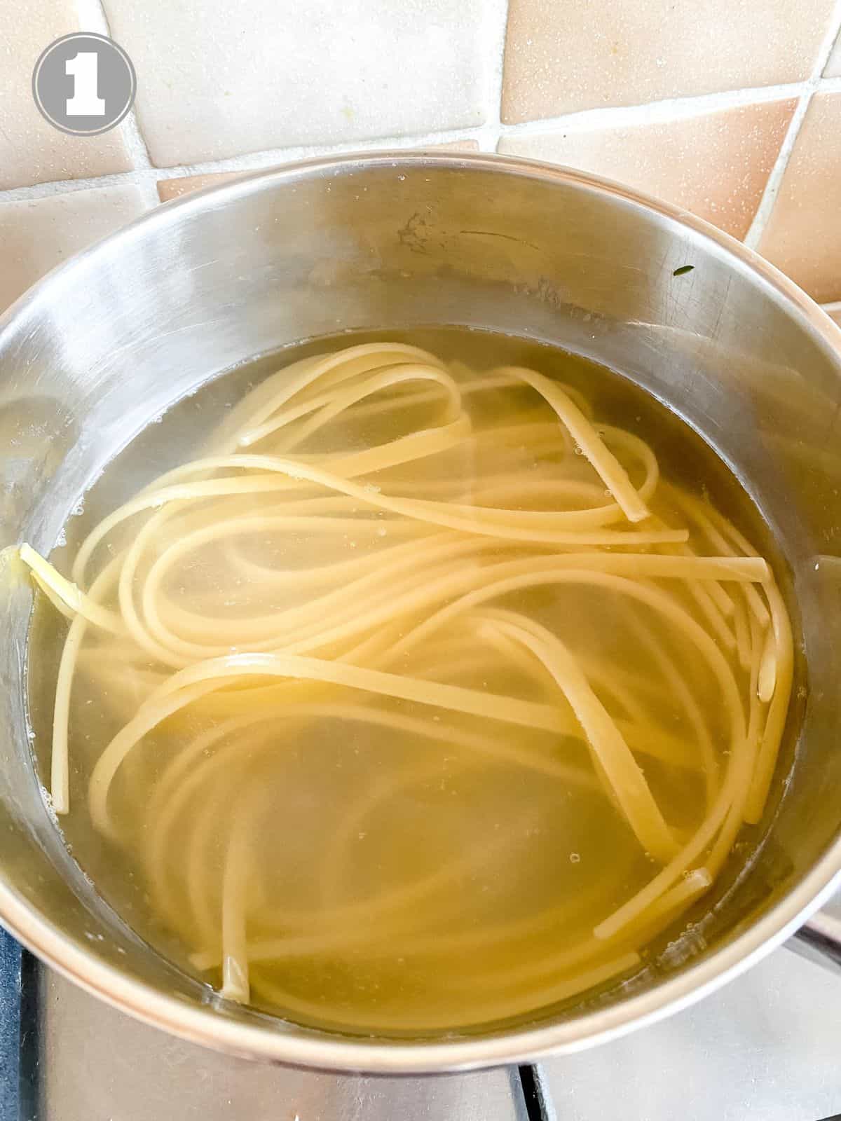 pasta in a pot of water labelled number one.