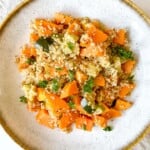 quinoa sweet potato bowl in a light grey bowl with a brown rim.