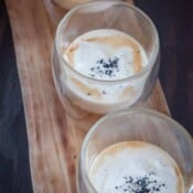 salted caramel drinks in three glasses on a wooden board.