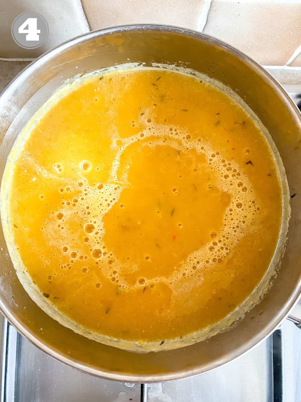 blended butternut squash and red pepper soup in a large pot labelled number four.