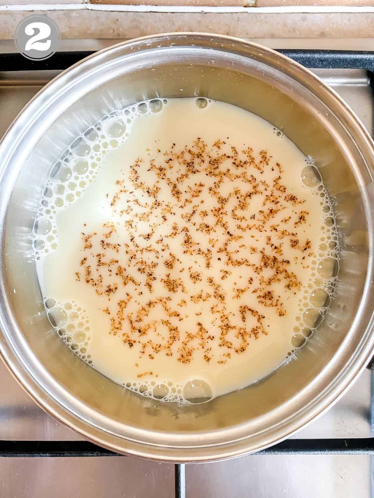 milk with nutmeg sprinkled on it in a pot labelled number two.