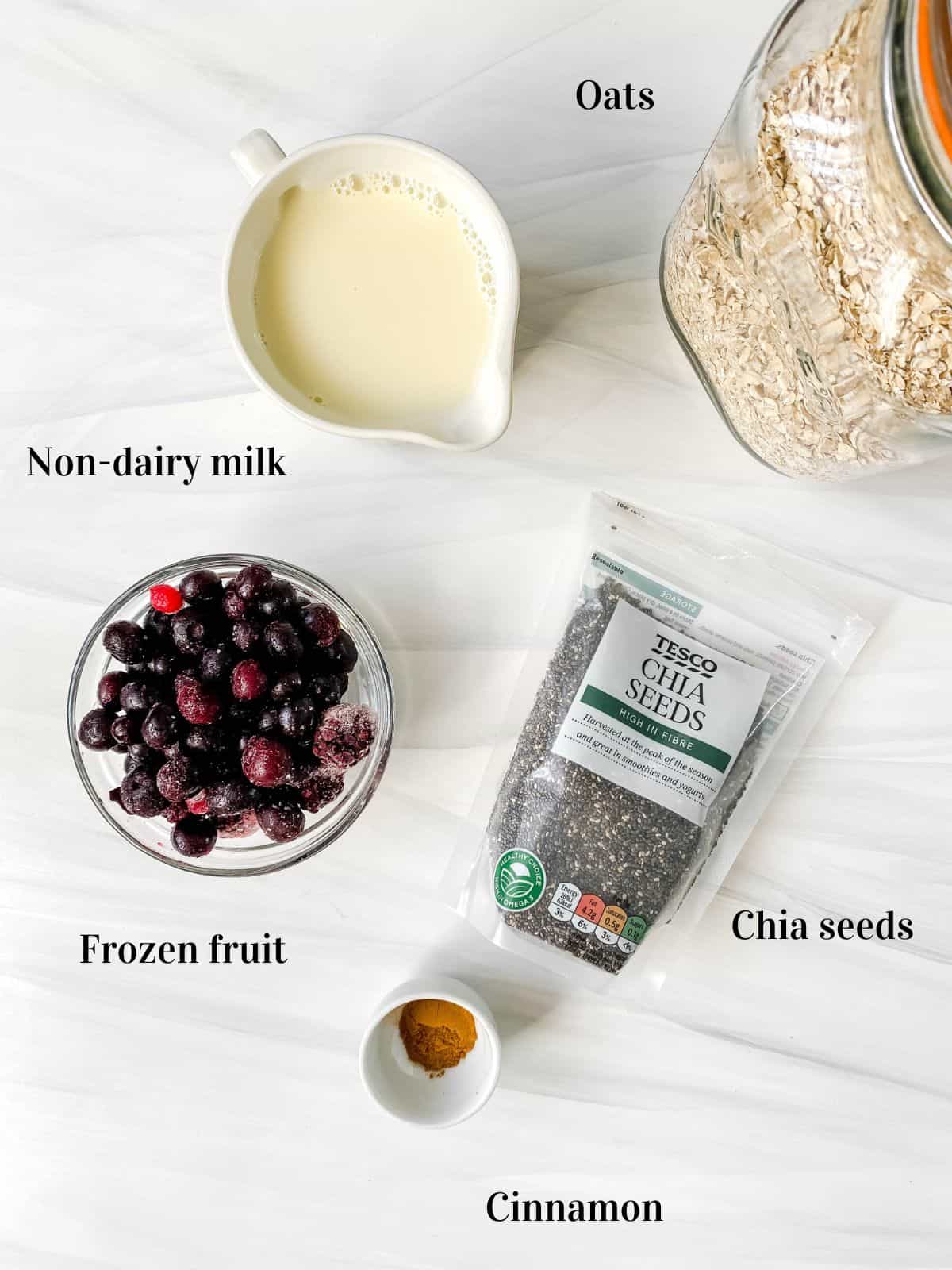 individually labelled ingredients to make overnight oats with frozen fruit including milk, chia seeds and oats.