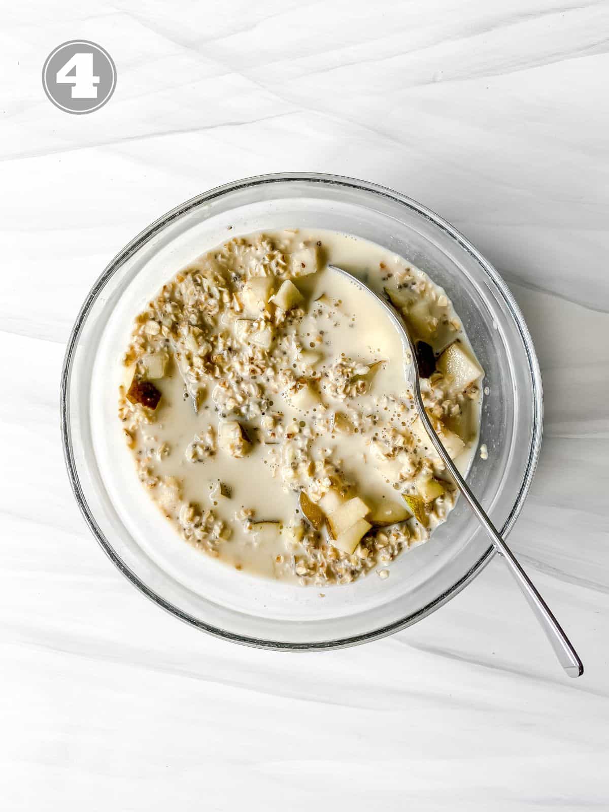 pear overnight oats in a glass bowl with a spoon in it labelled number four.