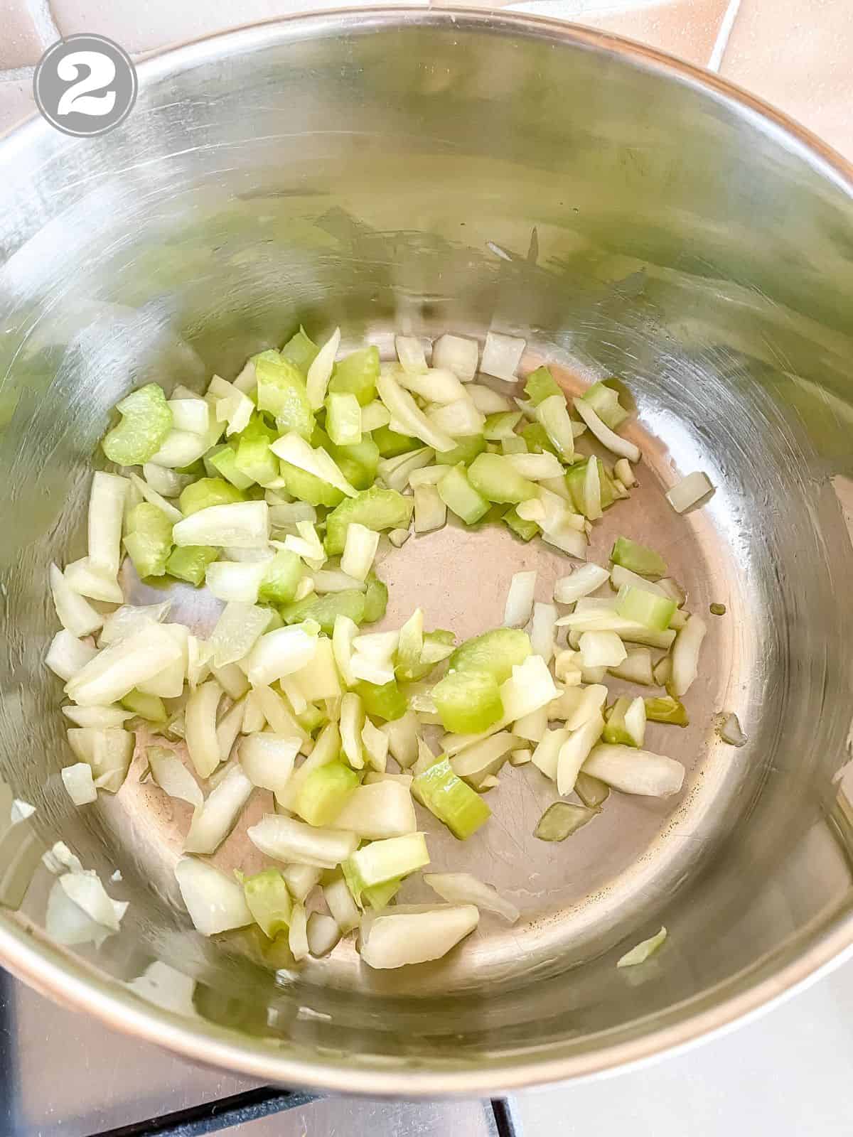 onion, garlic and celery in a pot labelled number two.