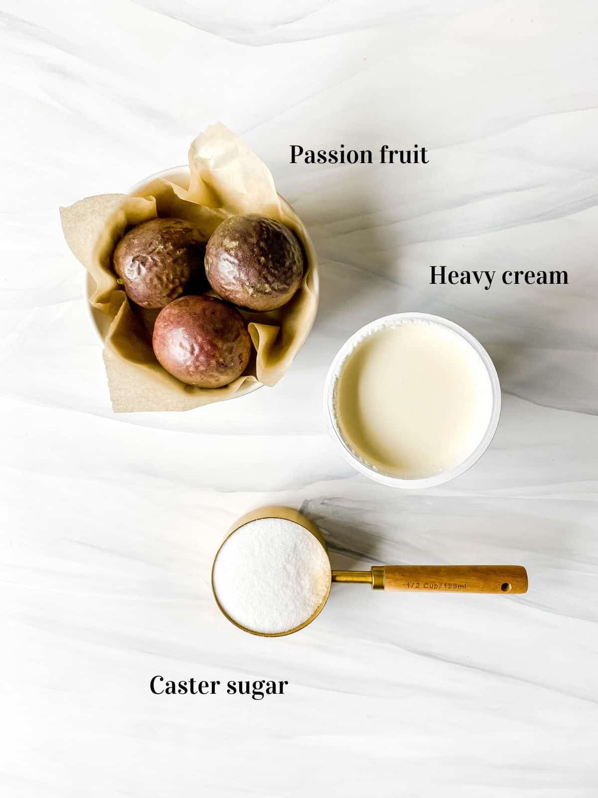 labelled bowl of passion fruit, carton of heavy cream and cup of white sugar.