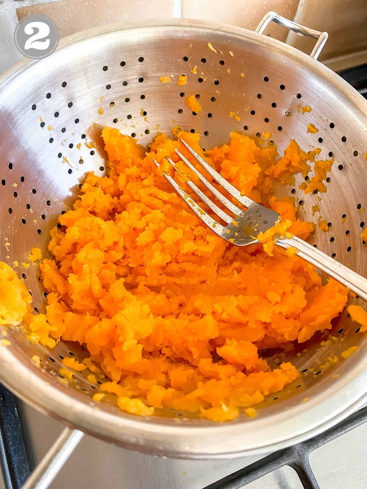 sweet potato mash in a colander with a fork labelled number two.