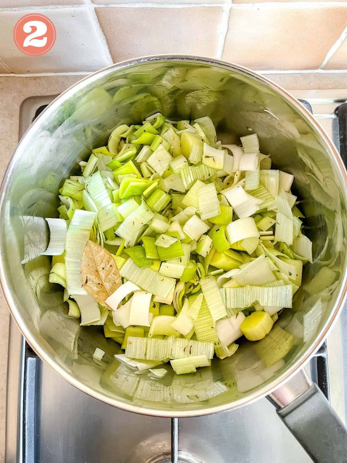 celery, leek and a bay leaf in a large pot labelled number two.