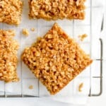 maple syrup flapjacks on parchment paper on a wire rack.