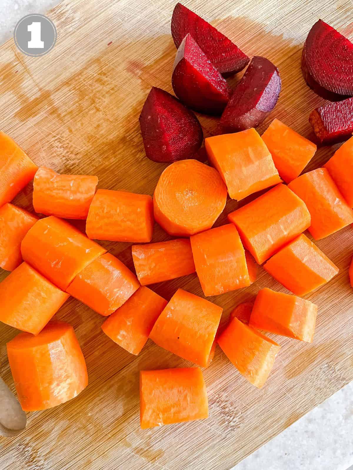 diced carrots and beets on a wooden chopping board labelled number one.