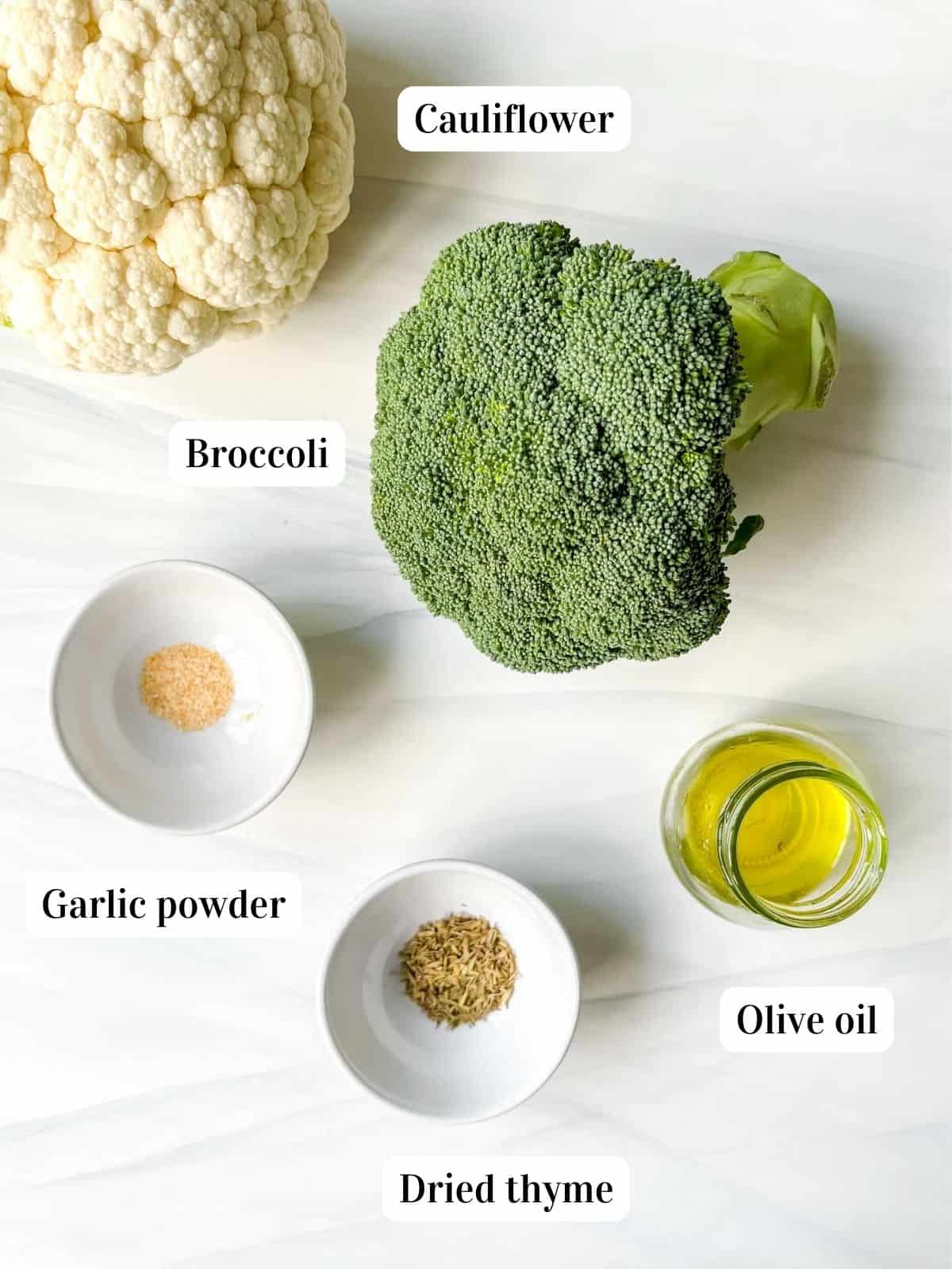 individually labelled ingredients to make air fryer broccoli and cauliflower including garlic powder, olive oil and thyme.