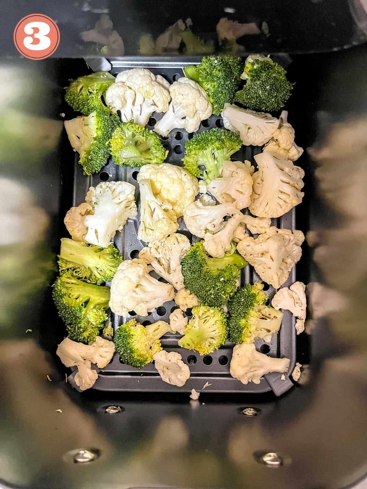 broccoli and cauliflower florets in an air fryer labelled number three.