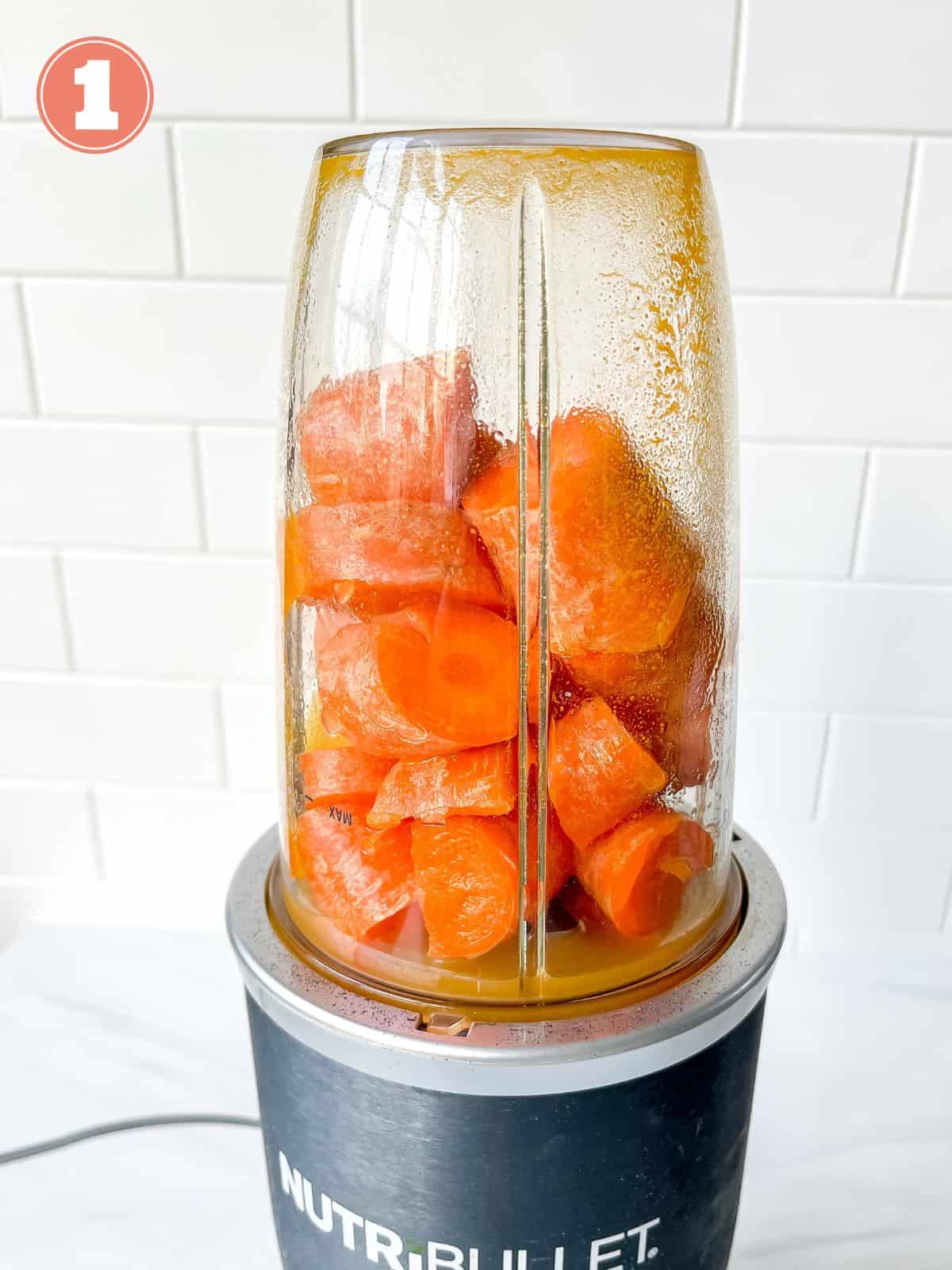 carrots in a blender in front of a white tiled wall labelled number one.