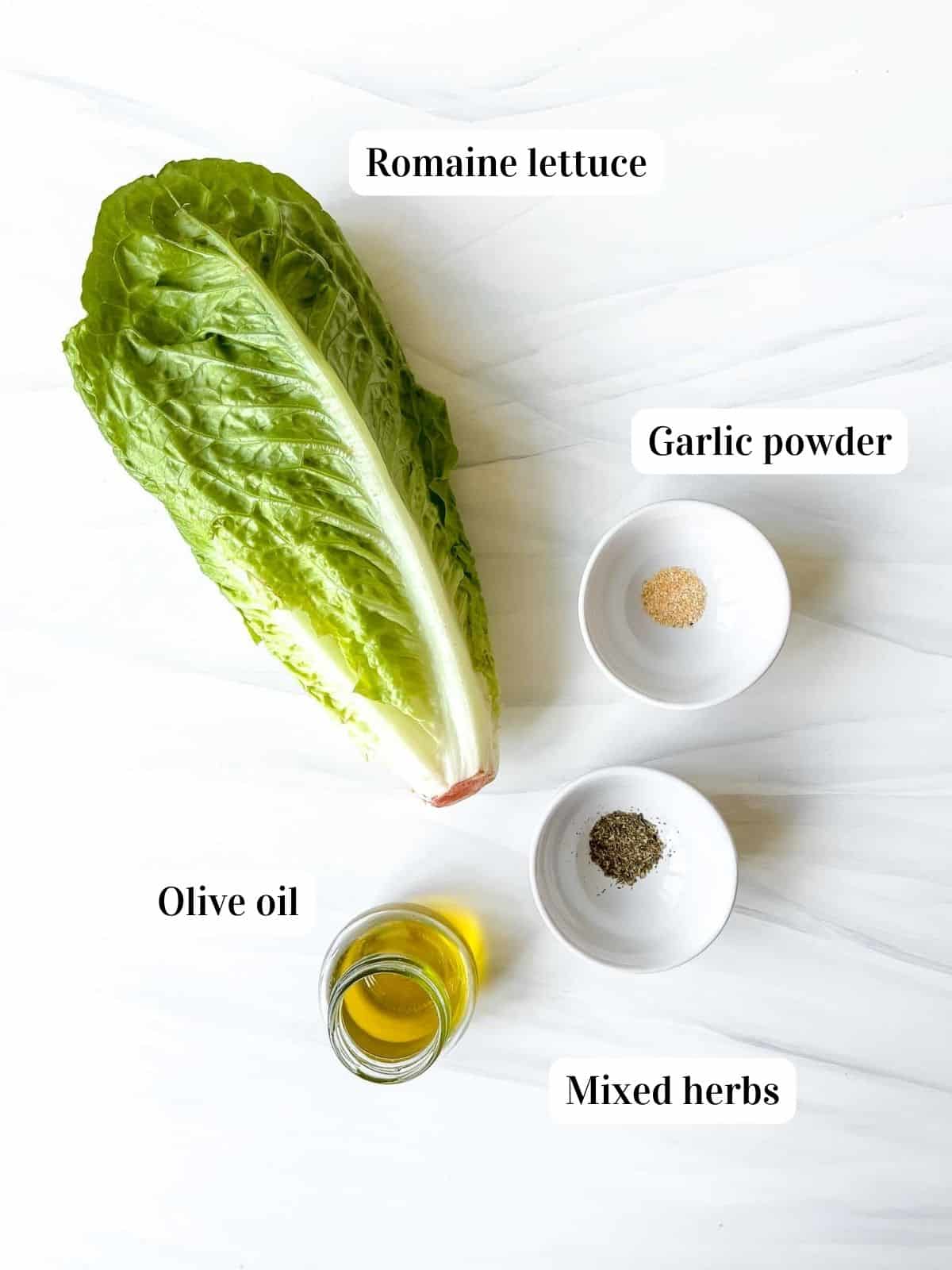 individually labelled ingredients to make air fryer romaine lettuce, bowls of garlic powder and mixed herbs.