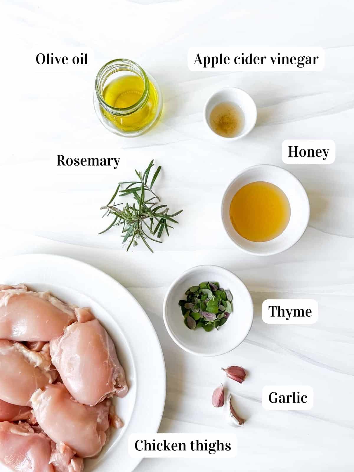 individually labelled ingredients to make baked rosemary thyme chicken including olive oil, garlic and honey.