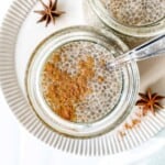 coffee chia pudding in two glasses on a cream plate next to star anise.