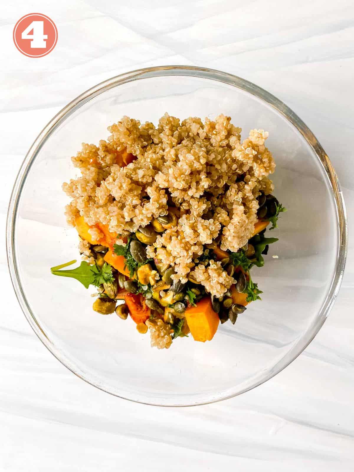 quinoa, pumpkin and arugula in a glass bowl labelled number four.