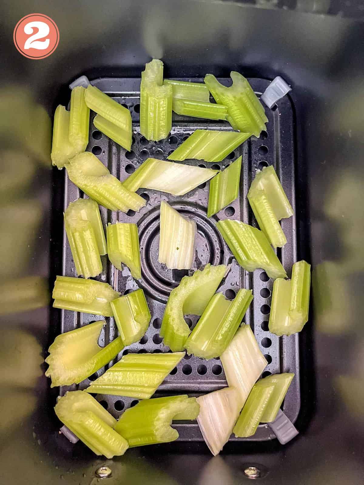 diced celery in an air fryer basket labelled number two.