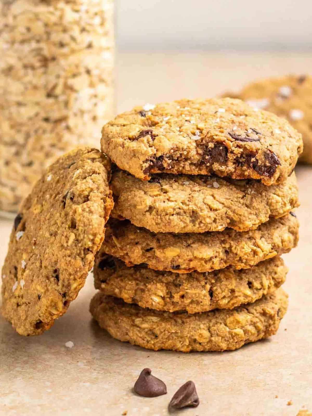 applesauce chocolate chips oatmeal cookies in a stack with a jar of oats in the background.