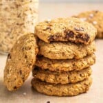 applesauce chocolate chips oatmeal cookies in a stack with a jar of oats in the background.