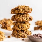 vegan sweet potato cookies in a stack next to a bowl of chocolate chips.