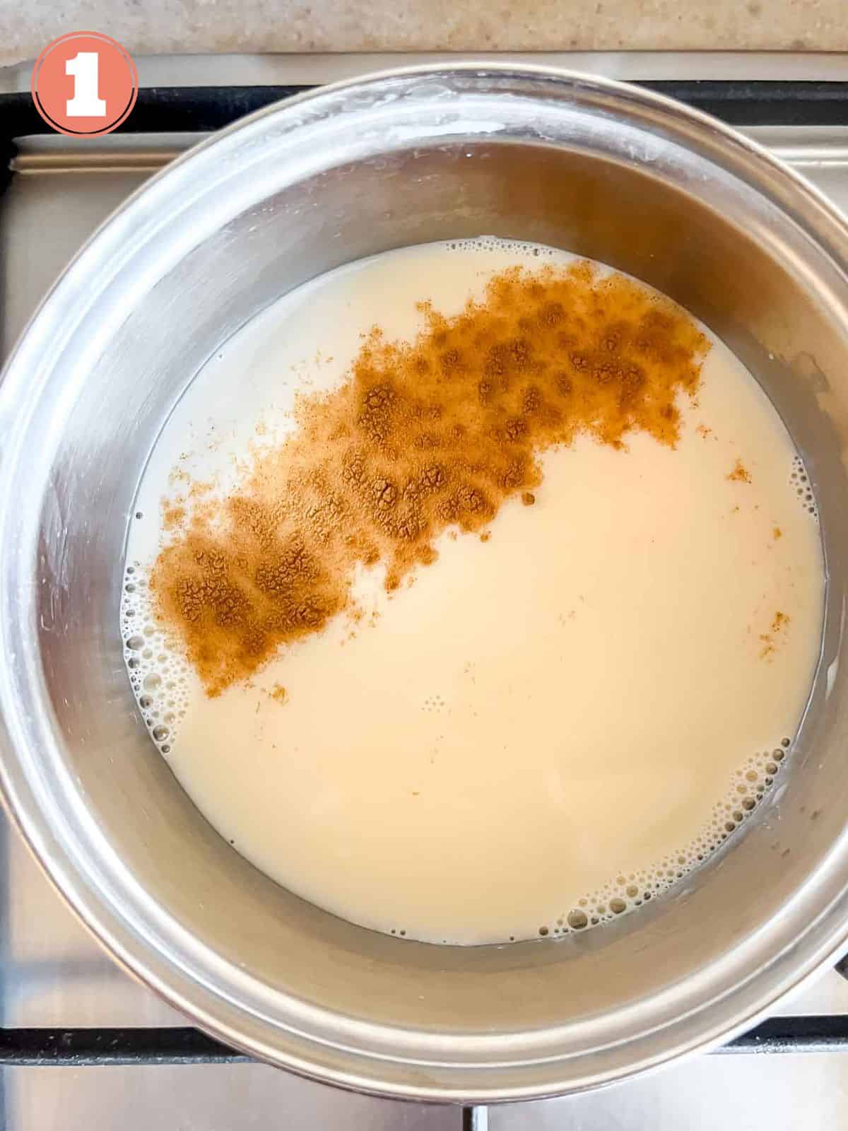 oat milk and cinnamon in a pot on a stove top labelled number one.