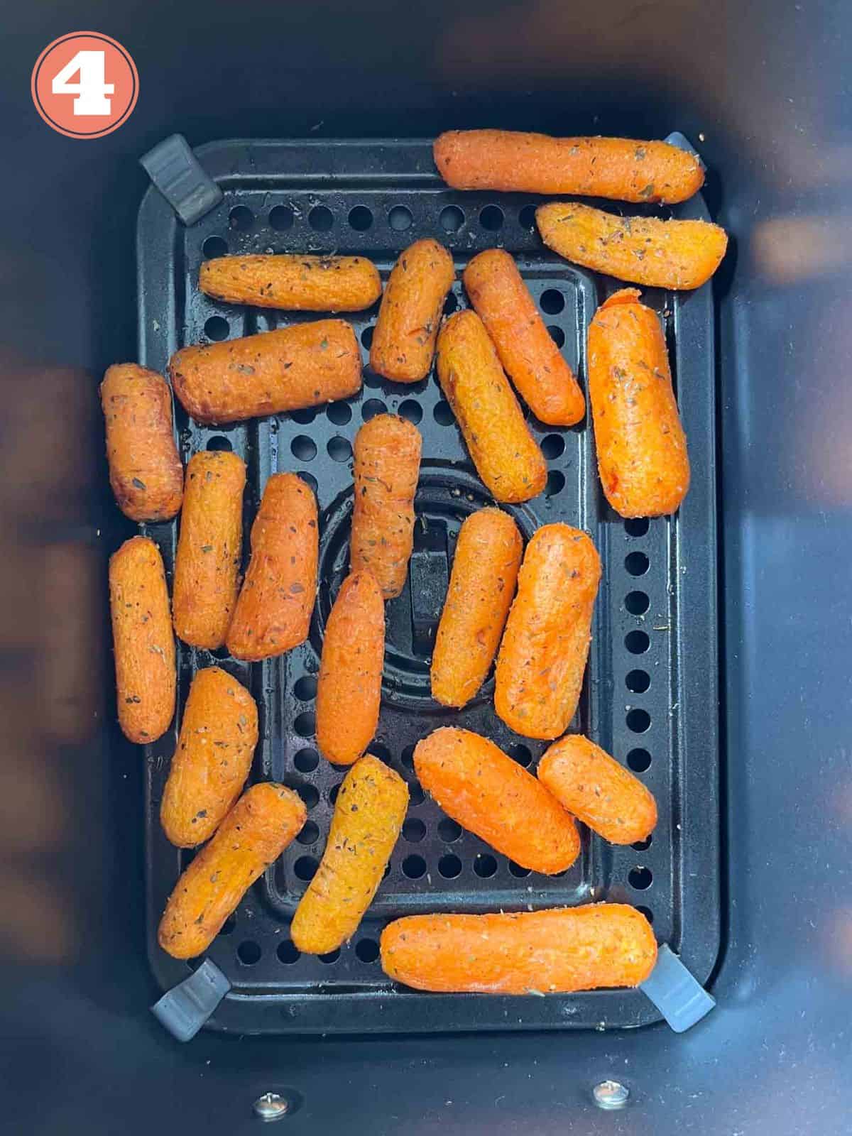 air fried baby carrots in an air fryer basket labelled number four.