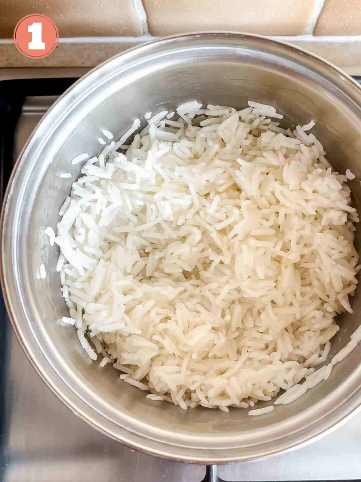 cooked rice in a pot on a stove top labelled number one.