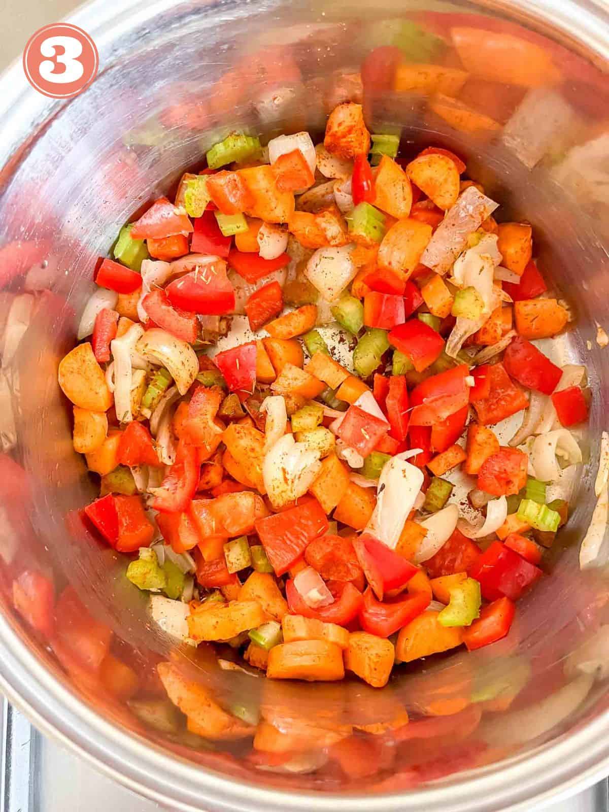 diced bell peppers, carrots, celery and onion in a soup pot labelled number three.