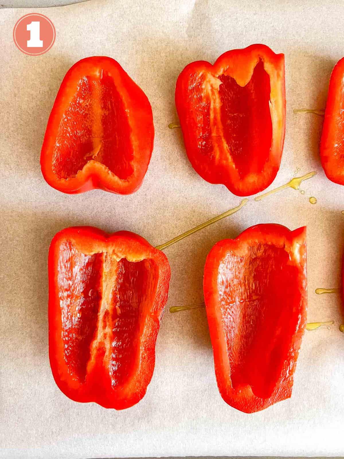 slice of red bell peppers on a baking sheet labelled number one.