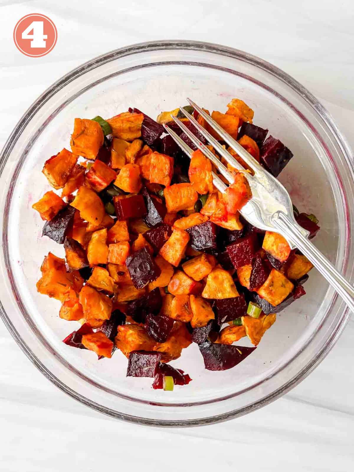 diced sweet potato cubes and diced beets in a glass bowl with a fork labelled number four.