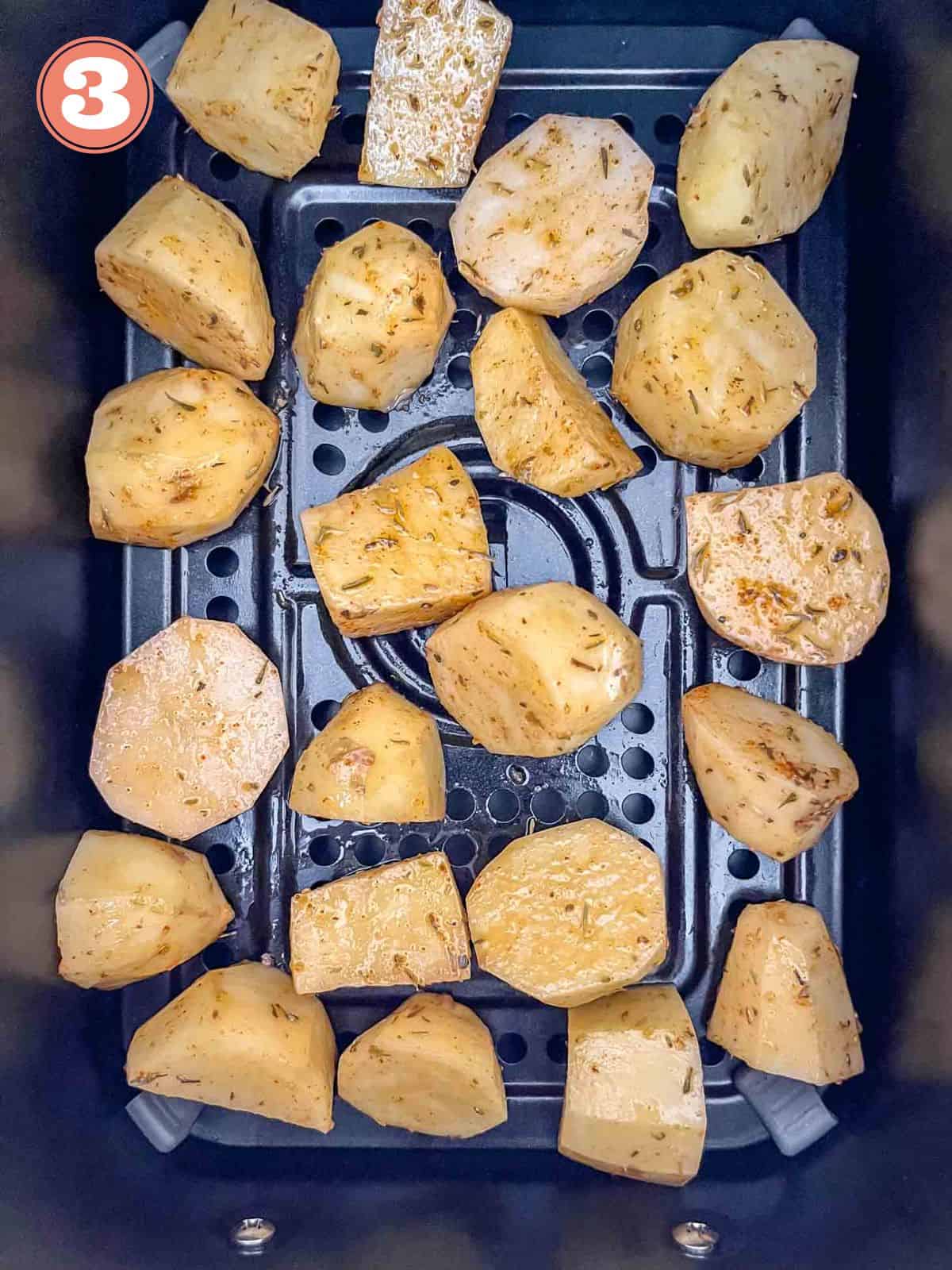 potato cubes in an air fryer basket labelled number three.