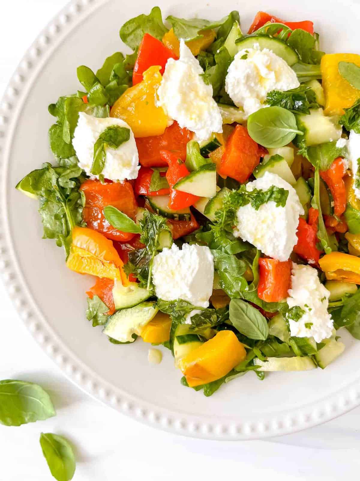 ricotta red pepper salad on a white plate.